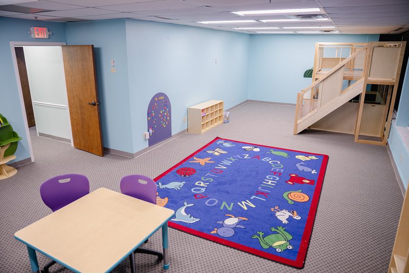 Step It Up ABA therapy room with a colorful play rug